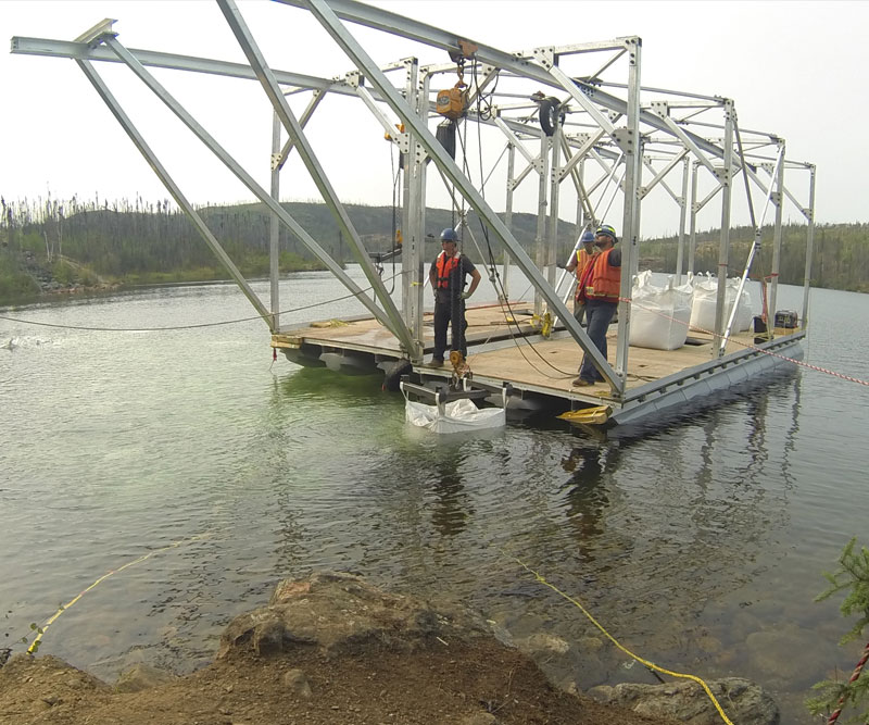 Cofferdam during construction using a floating crane system to lift the bags in place.