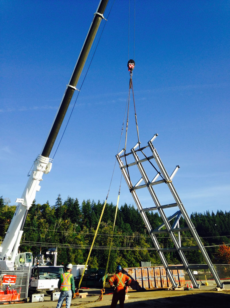 Hoisting of the new trash rack frame assembly for installation.